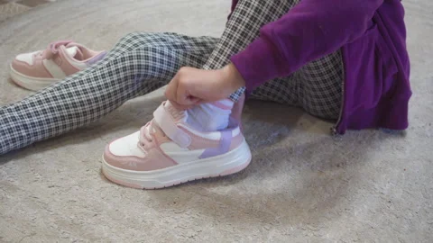 Child putting on sneakers Video stock 311067327