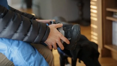 Child Putting on Snow Boots on Cold Winter Day Stock Footage 94133695