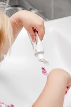 The child is putting the toothpaste Stock Photos