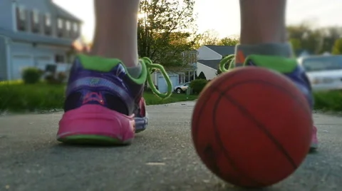 Child Racing Ball Down Hill at Sunset in Slow Motion Stock Footage 62799756