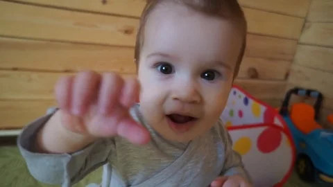 The child reaches for the camera. Stock Footage 74641449