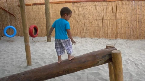 Child reaches the end of log learning balancing Stock Footage 67529684