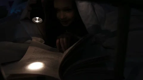 Child reading in bed Stock Footage 22636337