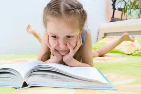 Child reading a book Stock Photos