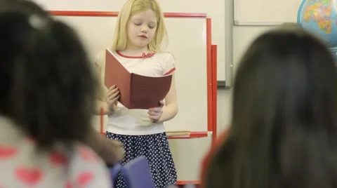 Child reading in front of class Stock Footage 22637464