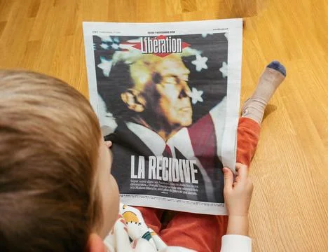 Child Reading Liberation Newspaper Stock Photos