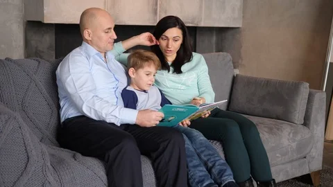 Child is reading with parents Video stock 89471287