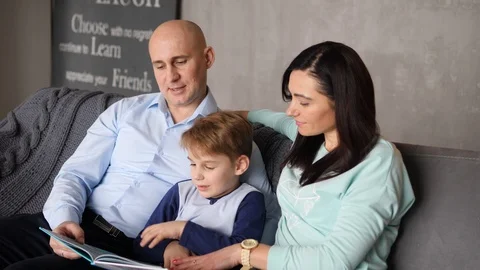 Child is reading with parents Video stock 89471824
