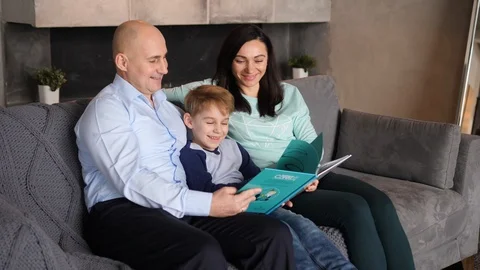Child is reading with parents Video stock 89471912