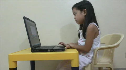 Child reading playing on a laptop Stock Footage 712412