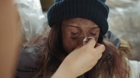 Child Receives Tender Care While Nose Is Wiped in Cold Shelter Video stock 329464218