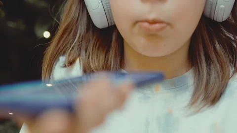 Child records an audio message on her phone. Stock Footage 301982160