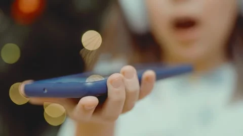Child records an audio message on her phone. Stock Footage 301982913