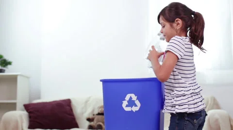 Child Recycles Plastic Bottles into Recycling Container Stock Footage 27962496
