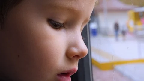 Child reflecting in the window, glass. Close-up shot of a kid looking out of the Stock-Footage 121877152