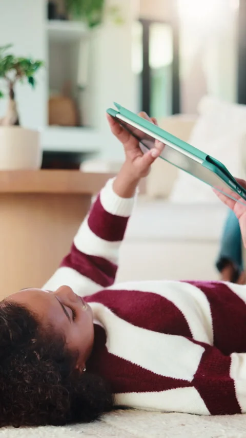 Child, relax and elearning with tablet in house, growth or skill development Stock Footage 335850349