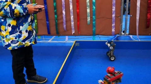 A child remotely controls boxing robots Stock Footage 122073615