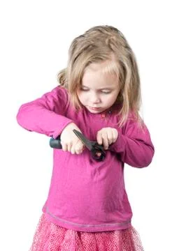 Child repairs the scissors Foto stock