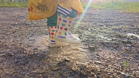 Child Repeatedly Taps A Muddy Puddle Stock Footage 339998971