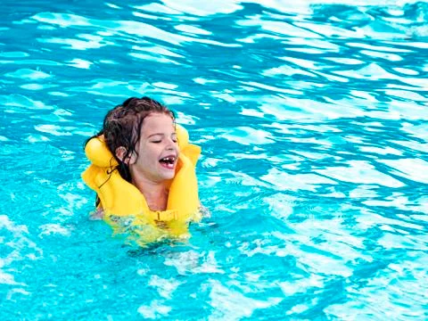 Child rest in the pool in summer Stock Photos
