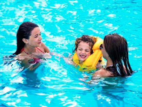 Child rest in the pool in summer Stock Photos