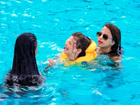 Child rest in the pool in summer Stock Photos