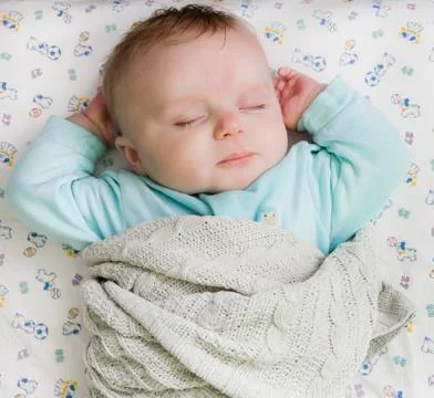 Child resting on a bed Stock Photos