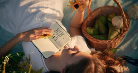 Child resting on grass lost in summer dreams Video stock 305661602