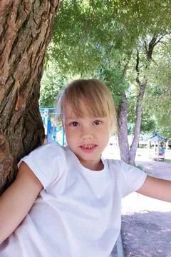 Child in reverie in tree. Stock Photos