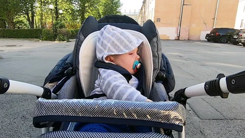 A child rides a stroller Stock Footage 131229005