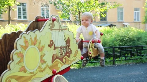 A child rides on a swing Stock Footage 133632089