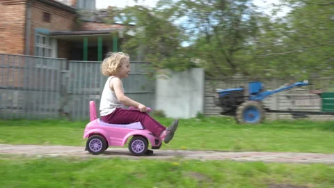 A child rides in a toy car Stock Footage 247309094