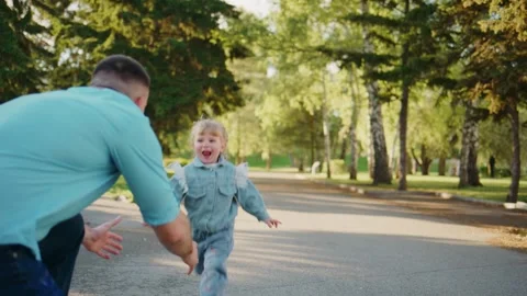 Child rides tricycle down tree-lined road Stock-Footage 335143810