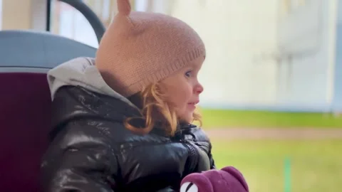 Child Riding Bus Sitting by Window with Toy Видео 333149644