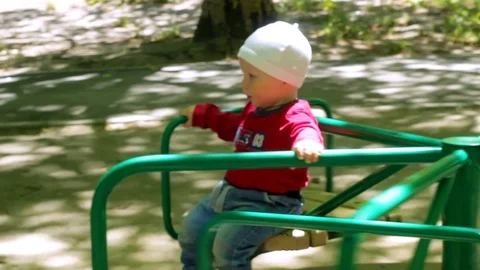 A child is riding a carousel Stock Footage 90379591