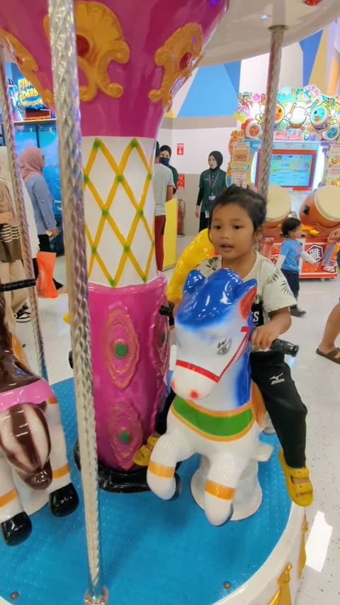 A child riding a carousel horse. Stock Footage 296315367