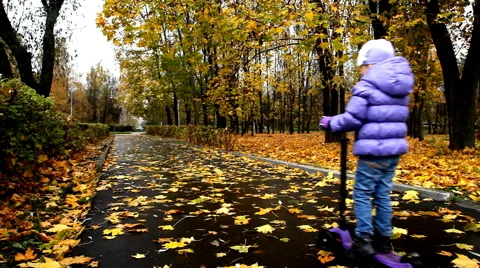 Child riding a scooter Stock Footage 68605575