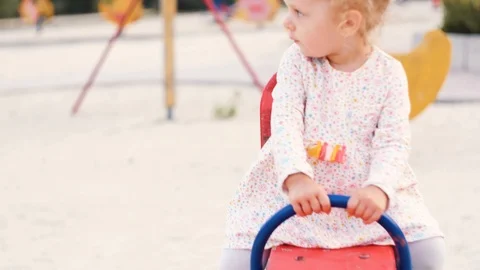 Child riding on a swing in the Playground Stock Footage 116715330
