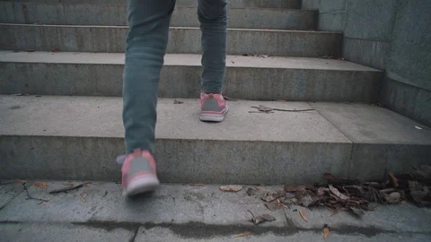 Child rises on the stone steps in city park. Stock Footage 106821095