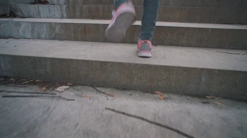Child rises on the stone steps in city park. Stock Footage 106821283