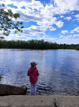 Child by the river 写真素材