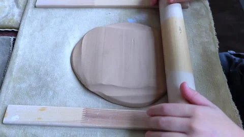 Child roll out clay for making plate close up. Children working on crafts. Stock Footage 291704639