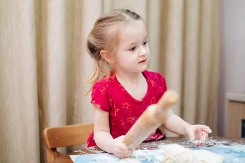 A child rolling a dough Stock Photos