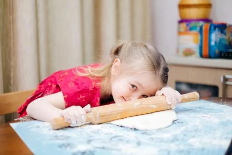 A child rolling a dough Stock Photos