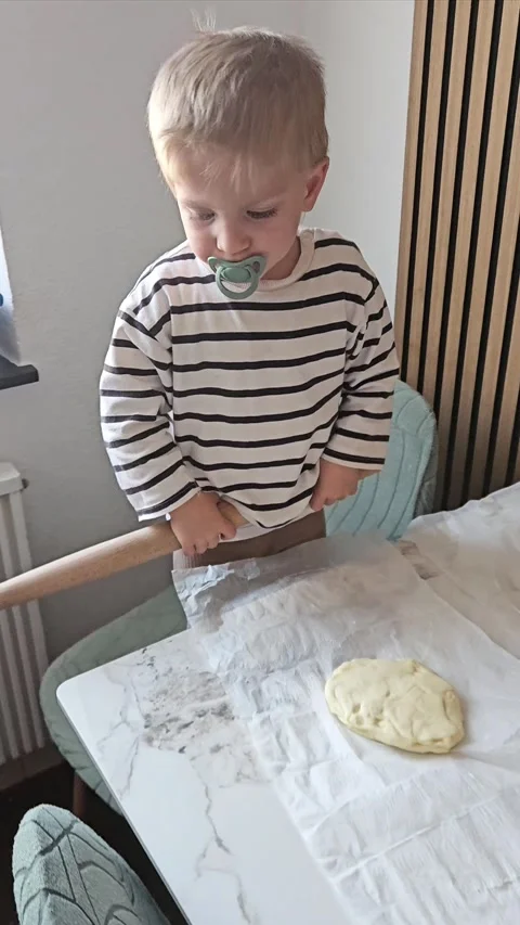 Child Rolling Dough with a Rolling Pin Stock Footage 304791278