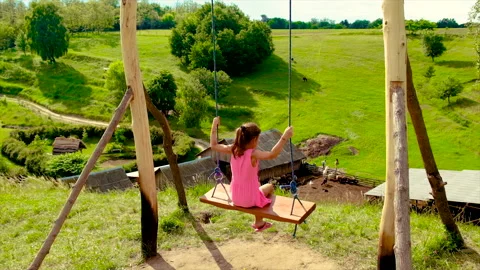 The child is rolling on a swing. Selective focus. Stock Footage 156595949