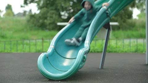 The child rolls down a children&amp;#039;s slide. Stock Footage 344811435