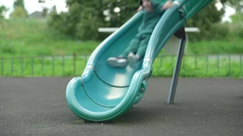 The child rolls down a children&amp;#039;s slide. Video stock 344811453