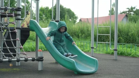 The child rolls down a children&amp;#039;s slide. Video stock 344811488