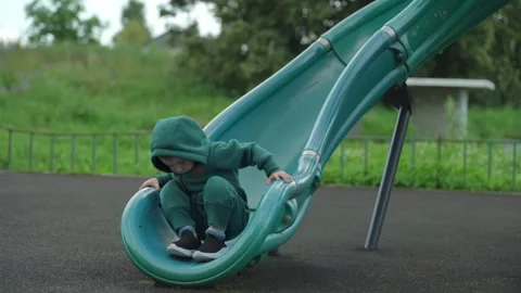 The child rolls down a children&amp;#039;s slide. Video stock 344811492